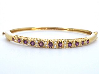 Gouden armband met diamanten en robijnen